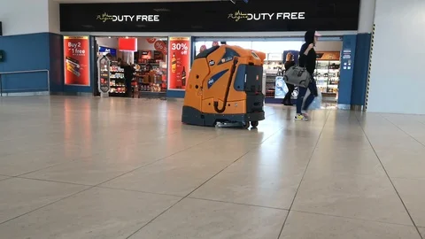 Automatic floor cleaner in action on prague airport hall,new technology Stock Footage 126580343