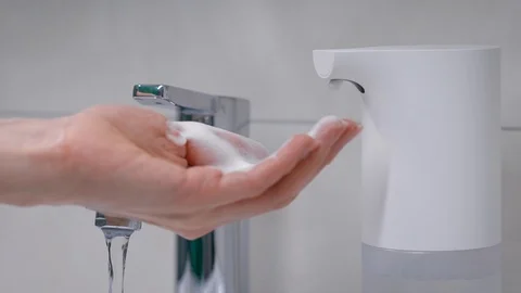 Automatic foam generator puts on hand the desired dose of soap. Women's hands Stock Footage 128749654