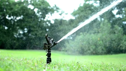 Automatic garden irrigation system watering lawn Savings of water from sprinkler Stock-Footage 334656783