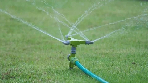 Automatic Garden Lawn sprinkler in action watering grass Stock Footage 72158166