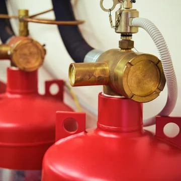 Automatic gas fire extinguishing system consisting of two red cylinders Stock Photos