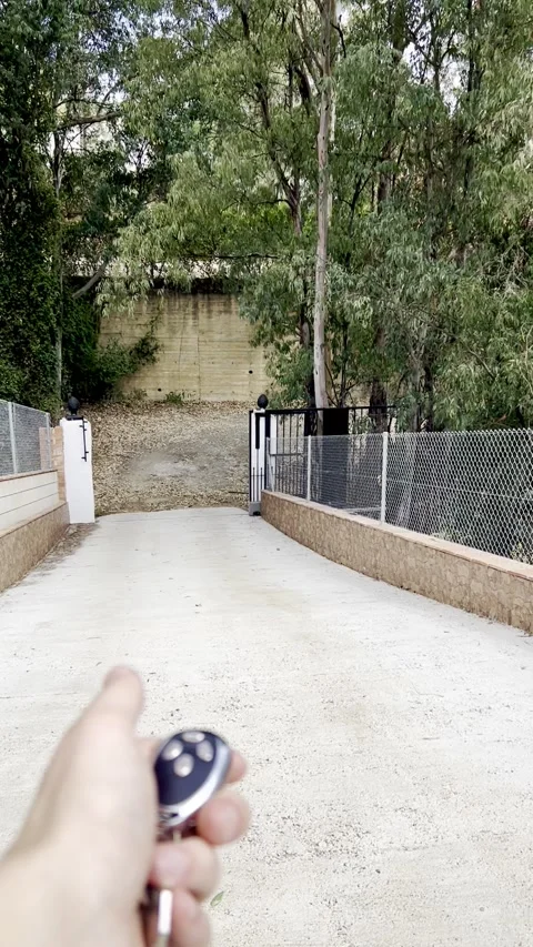 Automatic Gate does not open, man presses the button to open the gate Video stock 248706574