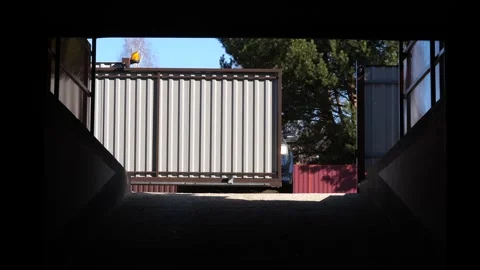 Automatic gates on a remote control open before entering the courtyard Video stock 270428468