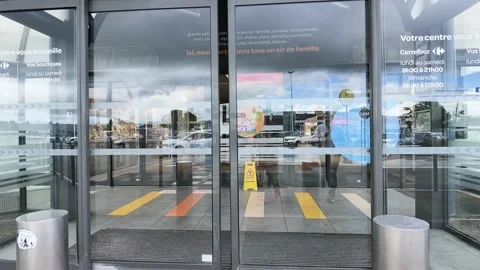 Automatic Glass Doors Opening at a Shopping Mall Entrance in Paris Stock Footage 335268172