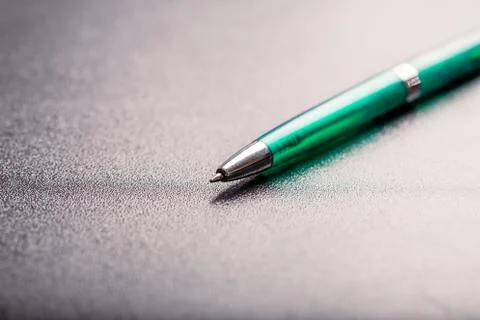 Automatic green plastic ballpoint pen with clipping path on black background. Stock Photos