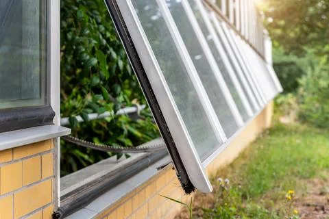 Automatic greenhouse ventilation window opens hydraulic opener regulate tempe Stock Photos