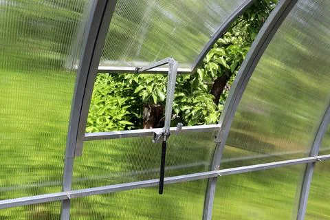 Automatic greenhouse window open to the garden Stock Photos
