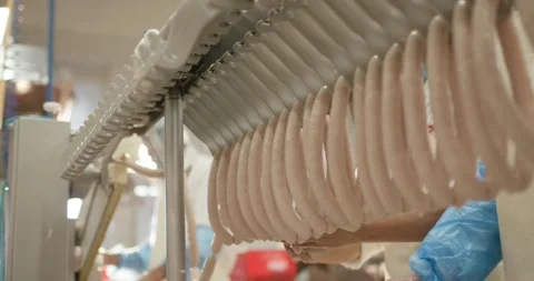 Automatic hanging machine loading fresh sausages onto smoking stick, Static Shot Stock Footage 340014468