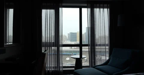Automatic hotel room curtains opening to cloudy city view Stock Footage 327652771