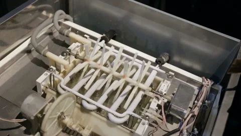 Automatic ice-making plant. plastic axis of the agitator rotates, stirring the w Stock Footage 129896213