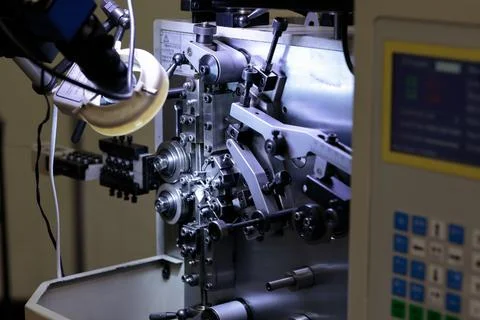 Automatic industrial CNC spring coiling machine Stock Photos