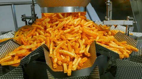 Automatic industrial scale distributes potato snacks to pack Stock Footage 74146905