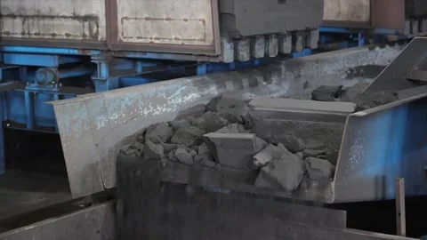 Automatic industrial shakeout machine breaking down sand molds Stock Footage 325321046