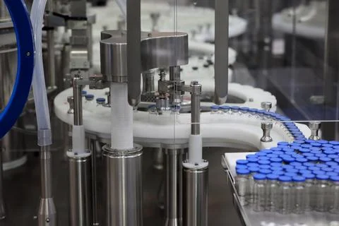 Automatic injection bottle cap sealing machine Stock Photos