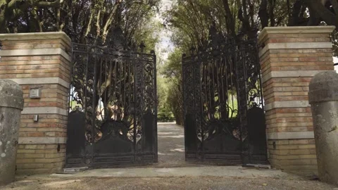 Automatic iron steel gate opening of countryside path leading to fancy Video stock 272615538