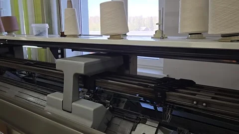Automatic knitting machine in operation in knitwear workshop at factory Stock Footage 334571807