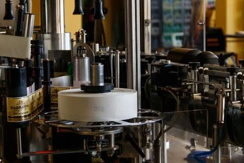 Automatic labeling machine equipment at Bagrationi factory of sparkling wine Stock Photos