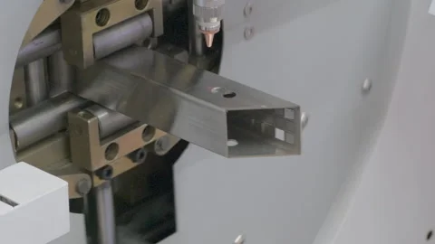 Automatic laser metal cutter in operation, processing and cutting steel part Video stock 296061602