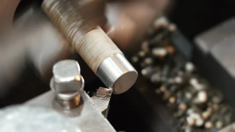 An automatic lathe processes an iron workpiece in a workshop. Stock Footage 306540321