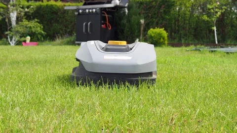 Automatic lawn mower robot moves on the grass, Stock Footage 188542803