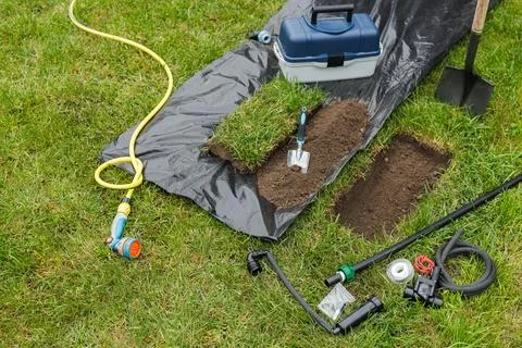 Automatic Lawn Watering System Installation with Tools and Equipment Stock Photos