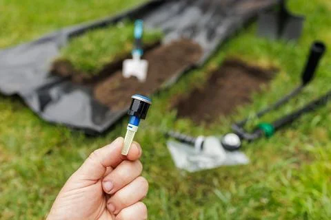 Automatic Lawn Watering System Installation with Sprinkler Nozzle Stock Photos