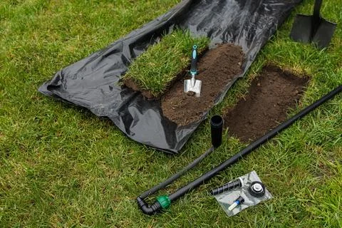 Automatic Lawn Watering System Installation with Tools and Equipment Stock Photos