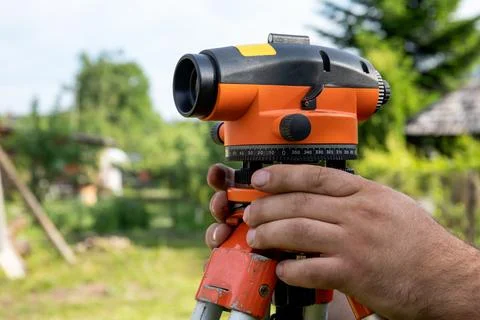 Automatic Level. Workers are working on the construction site and preparing for Stock Photos