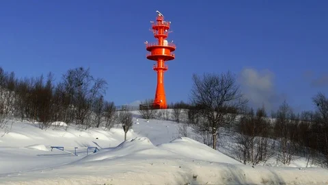 Automatic lighthouse on a snow-capped hill. Stock Footage 84173637