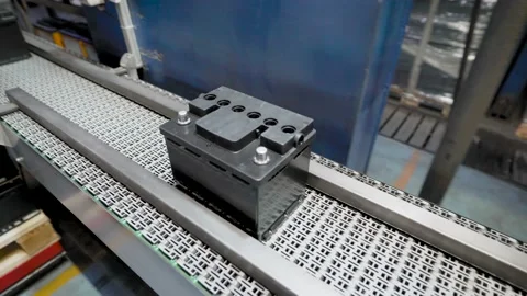 Automatic line for the assembly of car batteries. The black batteries move and Video stock 144168121
