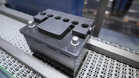 Automatic line for the assembly of car batteries. The black batteries move and Stock Footage 144496146