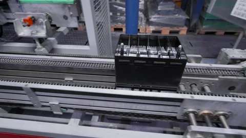Automatic line for the assembly of car batteries. The black batteries move and Stock Footage 144655899