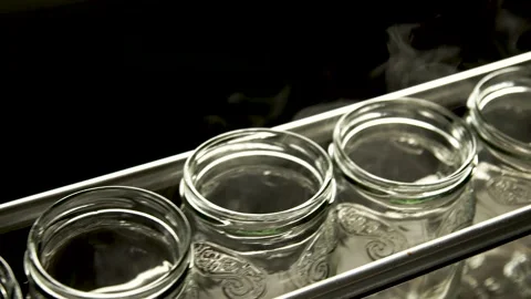 Automatic Line empty Glass cans for Processing of Vegetables. Glass jars on a Stock Footage 165773738
