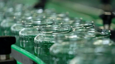 Automatic Line empty Glass cans for Processing of Vegetables. Glass jars on a Stock Footage 165774311