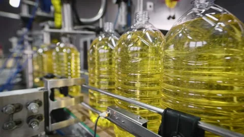 Automatic line for packaging and filling PET containers with sunflower oil. Stock Footage 168962327