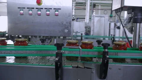 Automatic Line for Processing of Vegetables. Preserving Tomatoes and cucumbers Stock Footage 127862660