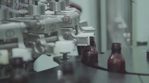 Automatic Liquid Bottling Machine Filling Bottles in Pharmaceutical Factory Stock Footage 340600765