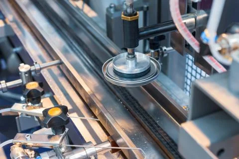 Automatic machine for blocking cans with paint. Stock Photos