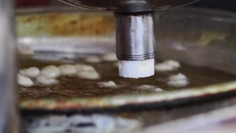 Automatic Machine Dropping Dough into Hot Oil for Frying 動画素材 343358135