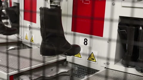 Automatic machine for making boots ankle boots shoes for police and military Stock Footage 125896042