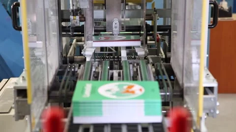 Automatic machine operating in the printing house, stacking books Stock Footage 131504785
