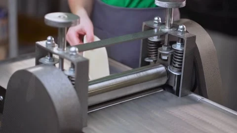 An automatic Machine rolling out homemade pasta and stretching the dough in work Stock Footage 189262895