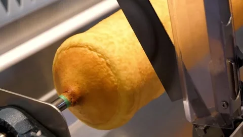 Automatic Machine Slicing Freshly Baked Baumkuchen Cake Stock Footage 331775184