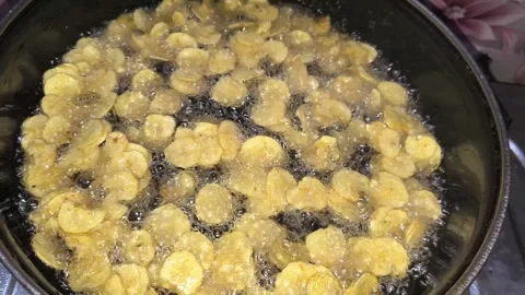 Automatic Machine Slicing Green Plantains into Thin Rounds for Frying Stock Footage 326021246