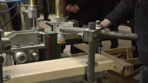 Automatic machine tool makes holes in wooden details of furniture by drilling in Stock Footage 147078362
