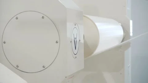 Automatic machine turns roll of adhesive tape in workshop Stock Footage 133359776