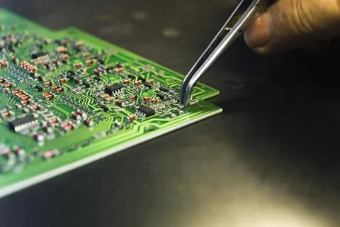 Automatic machines versus human precision. Hand assembly concept. Unrecognizable Stock Photos
