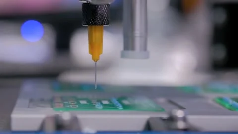 Automatic manipulator with dispenser needle dispensing solder paste on SMT pcb Stock Footage