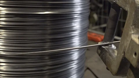 Automatic mechanical unwinder for interlocking drawn steel wire to a bending mac Stock Footage 106735154
