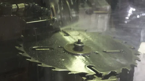 Automatic Metal blade sharpening in C&amp;C machine at the factory making a saw Stock Footage 95583759